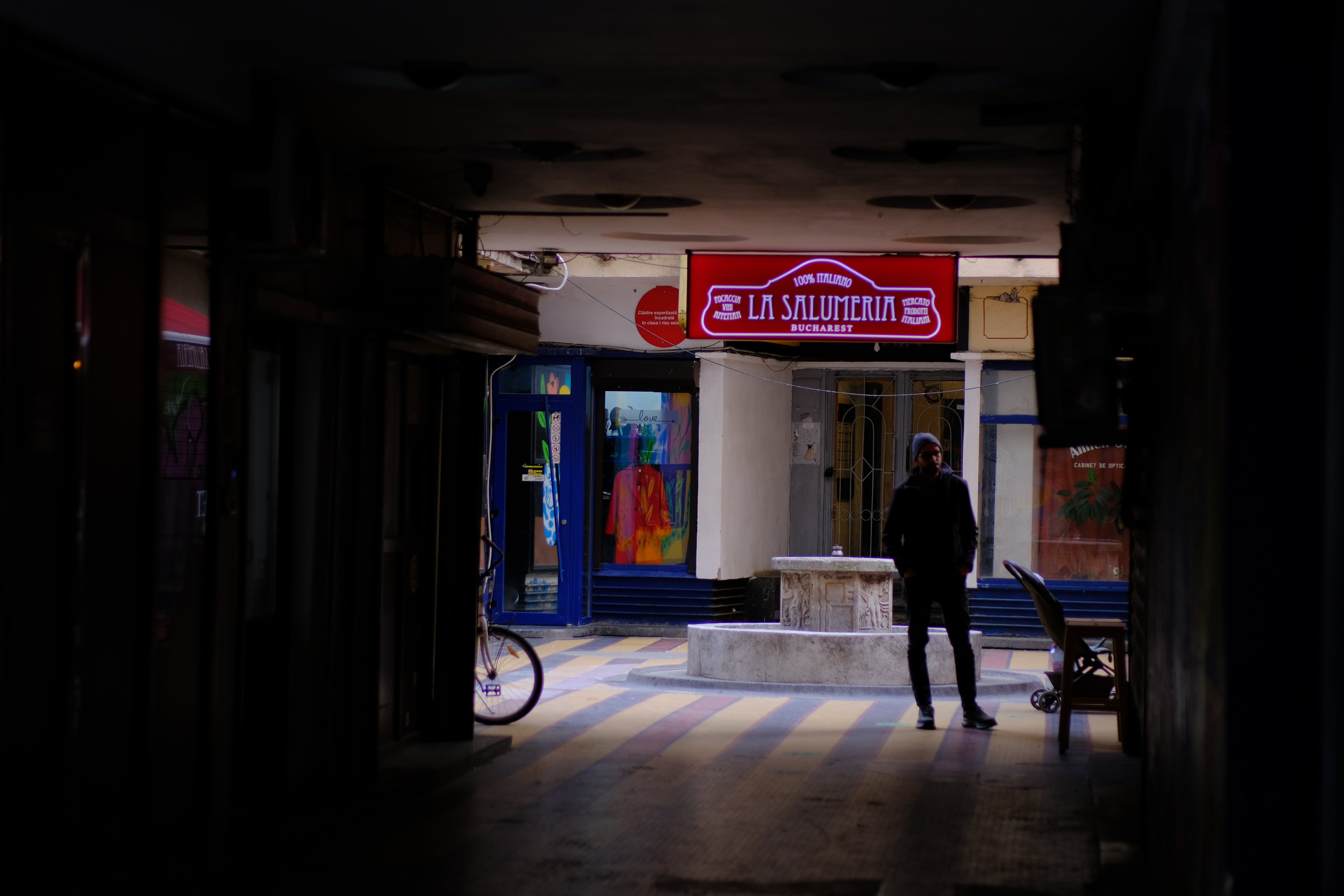 Red neon sign and a lone figure
