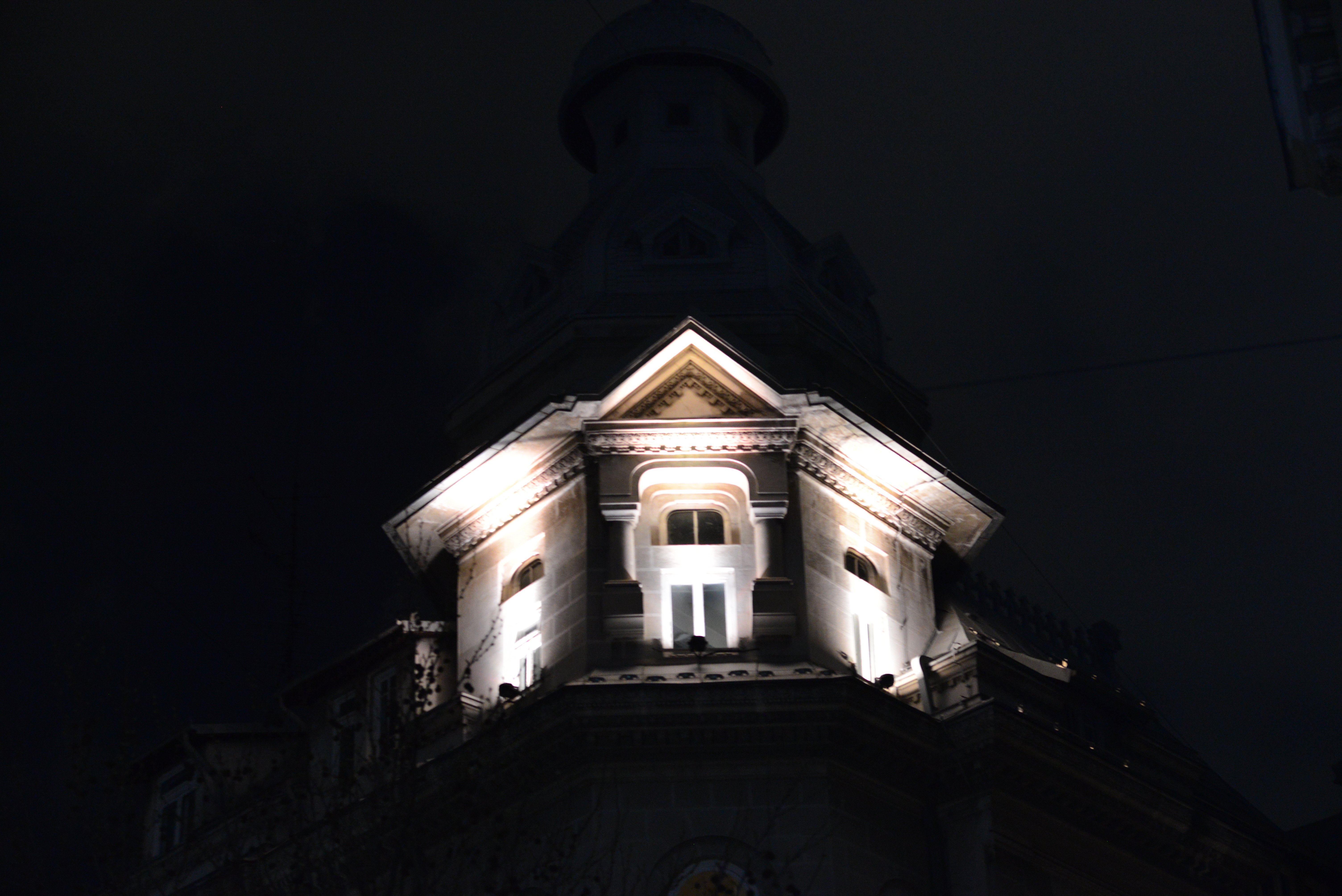 Spotlit tower against a dark sky